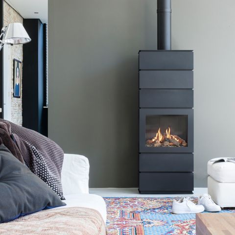 Free-standing fireplace burning in a living room